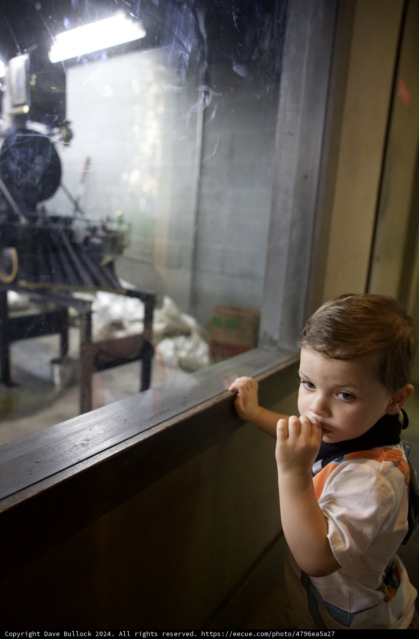 A Curious Gaze: Young Explorer at the Train Station