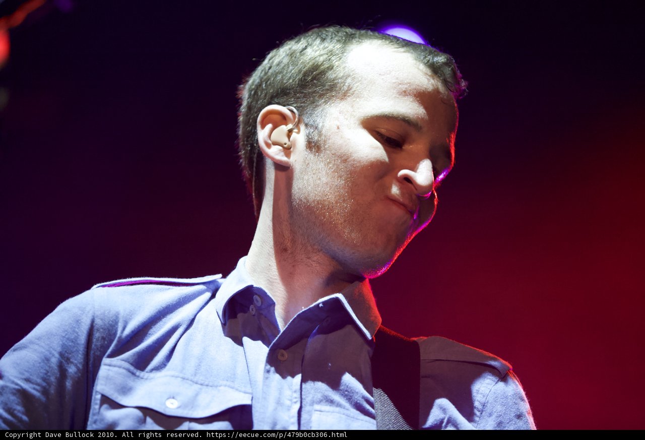 Blue Shirted Chris Baio Electrifies the Stage with his Music