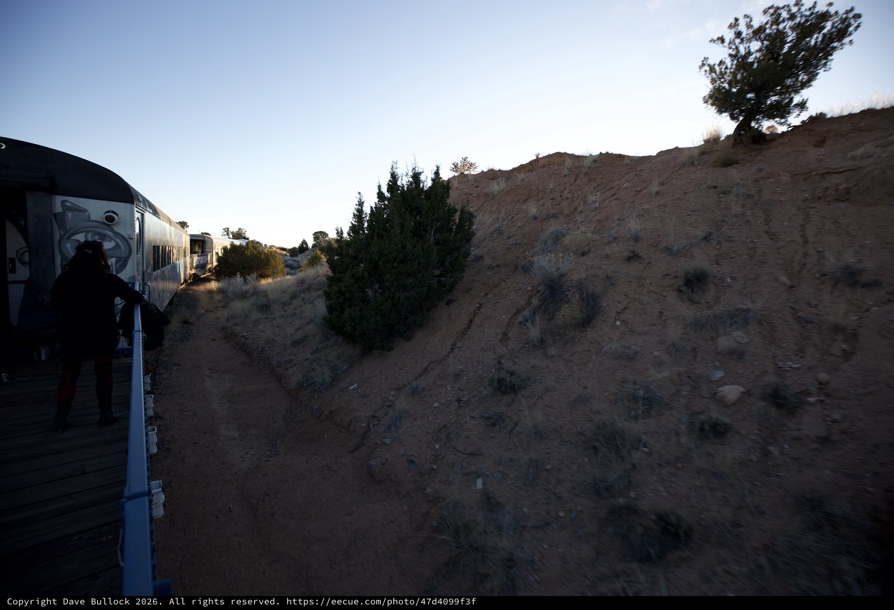 Sunset Train Journey Through Desert Landscape