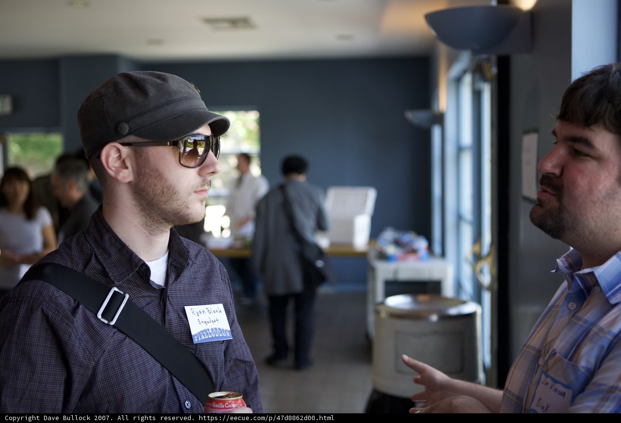 Two Men Discussing Over a Cup of Coffee