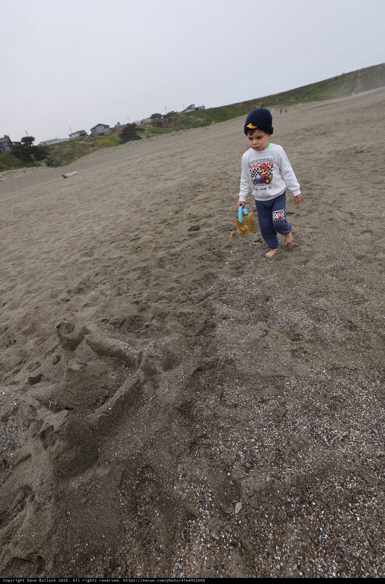 Young Explorer Walking Barefoot on Foggy Beach