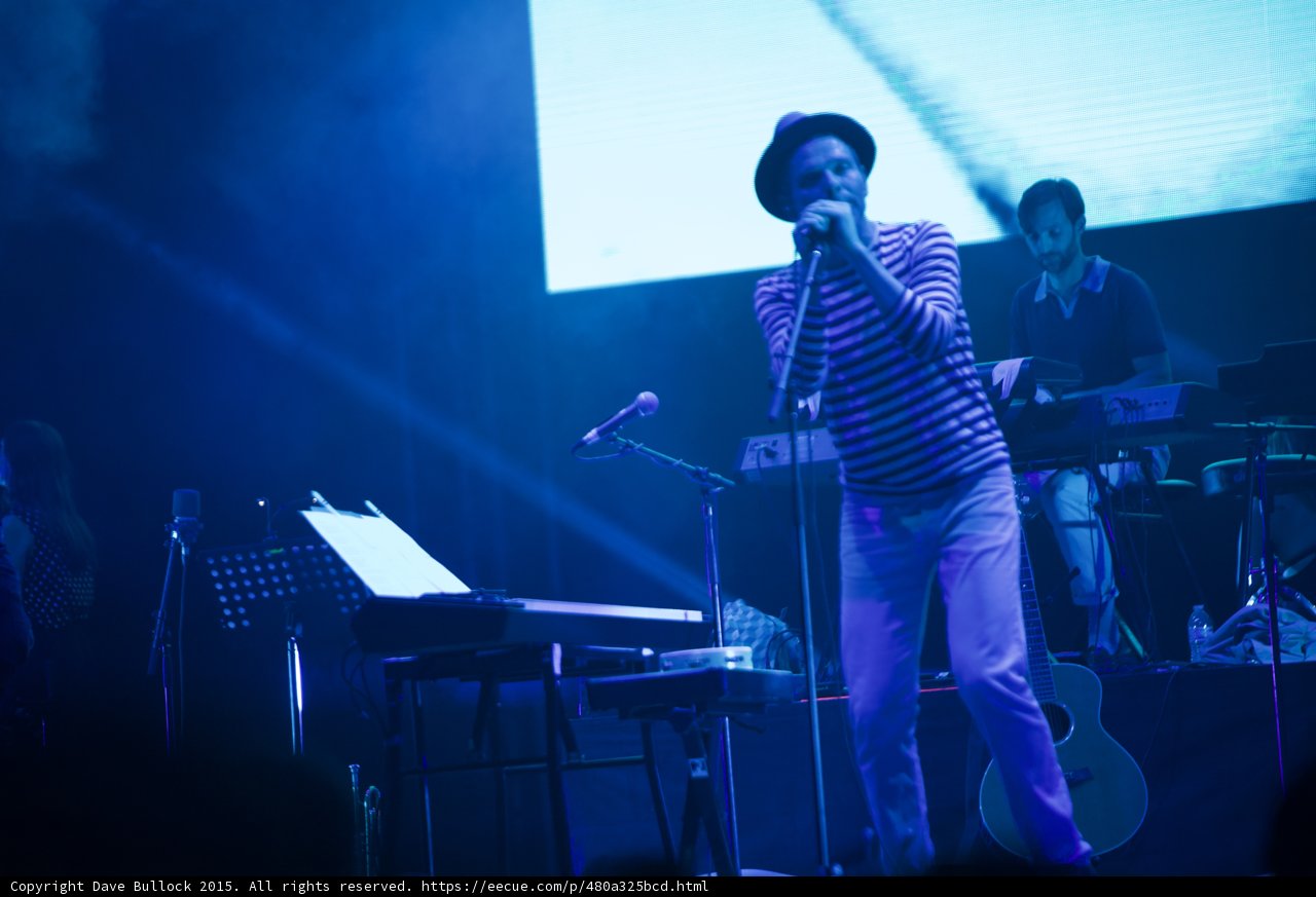 Belle and Sebastian Stuart Murdoch Singing Mic Fedora Striped Shirt Keyboardist Acoustic Guitar