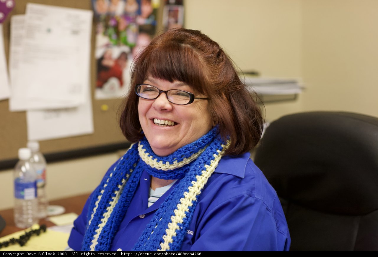 Portrait of a Happy Woman with Blue Scarf and Glasses