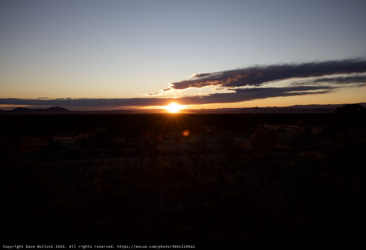 Desert Sunset Over Distant Mountain Ranges
