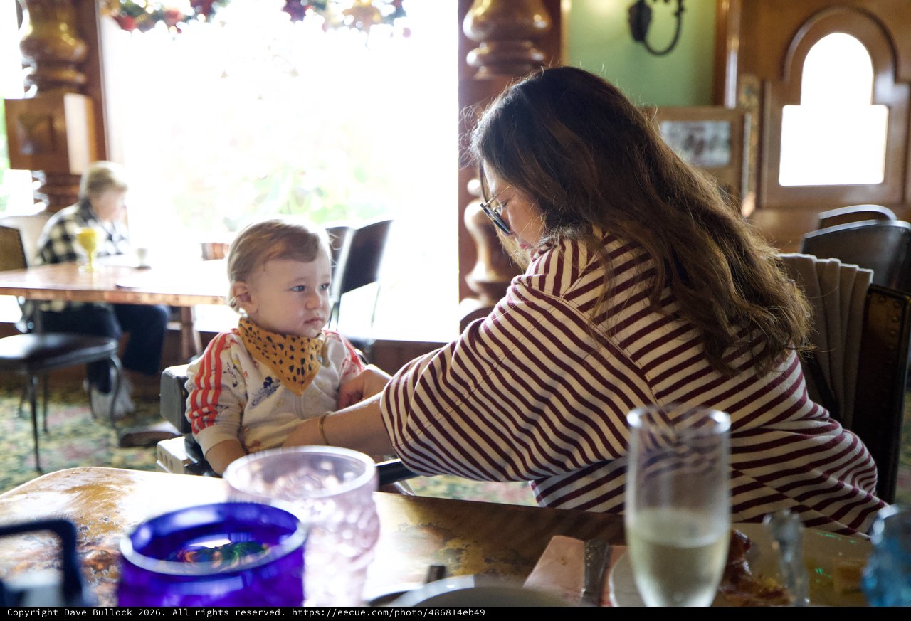 Mother and Child Sharing Mealtime at Restaurant Table