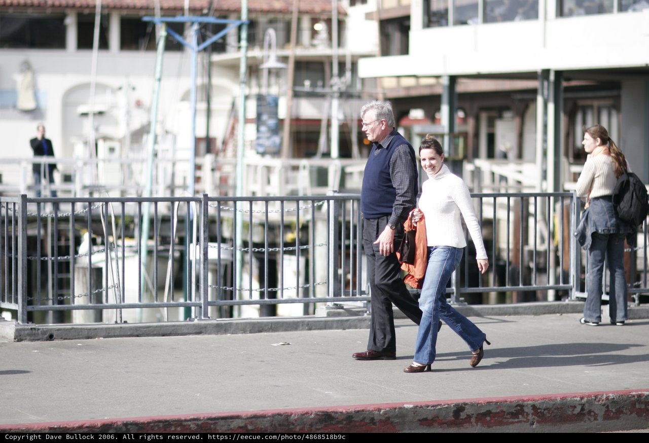 Couple Strolling Along San Francisco Waterfront Pier
