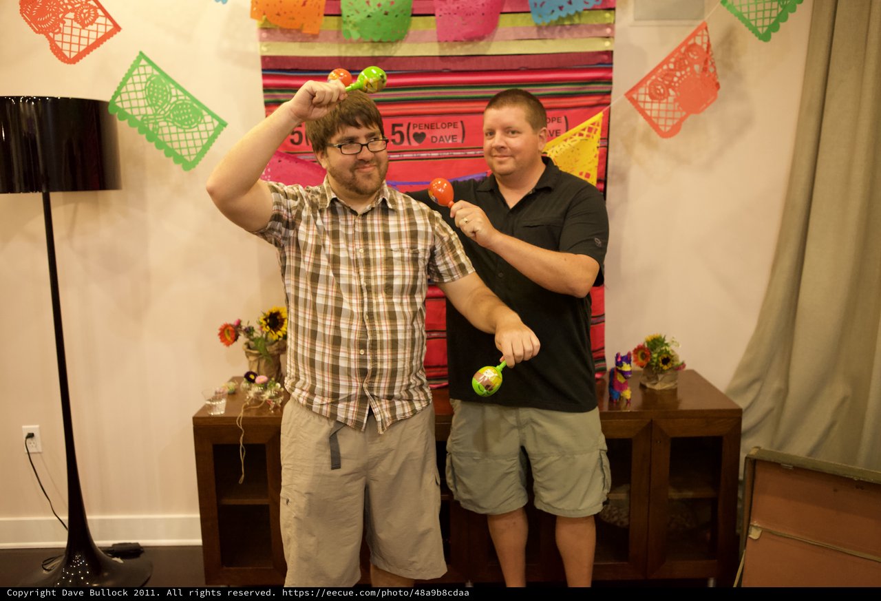Two Friends Celebrate with Maracas at Fiesta Party