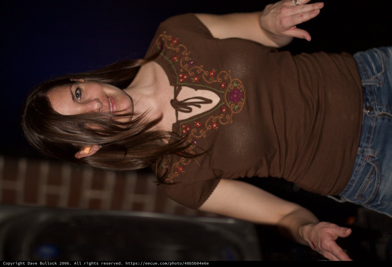 Woman Dancing Joyfully at Indoor Nighttime Event