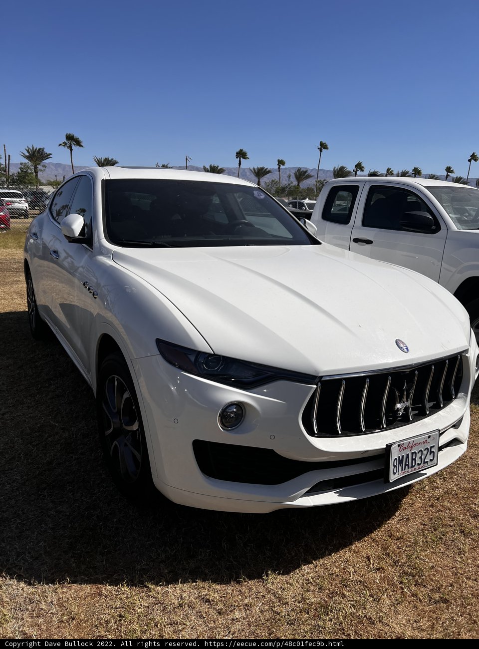 White Maserati Surrounded by Black Cars