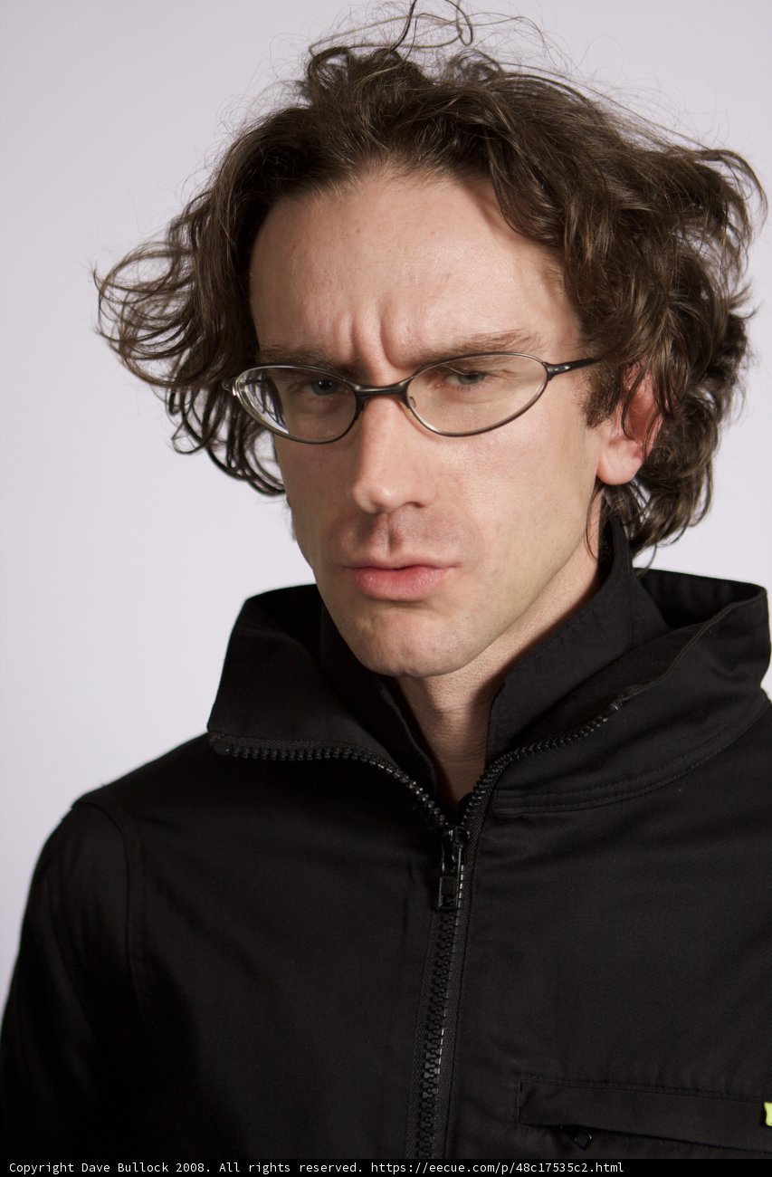 Curly-Haired Man in Jacket