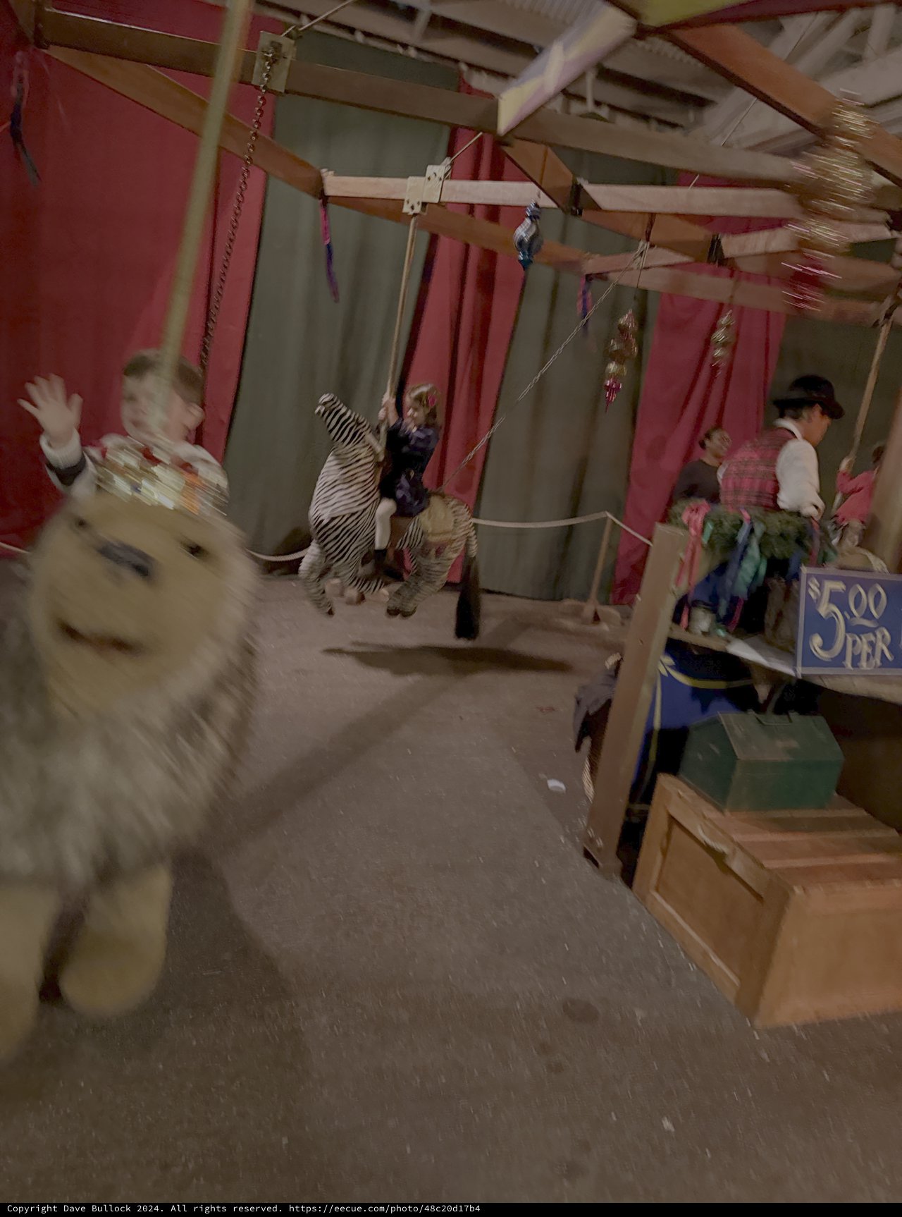 Blurry Carousel Scene with White Animal Figure