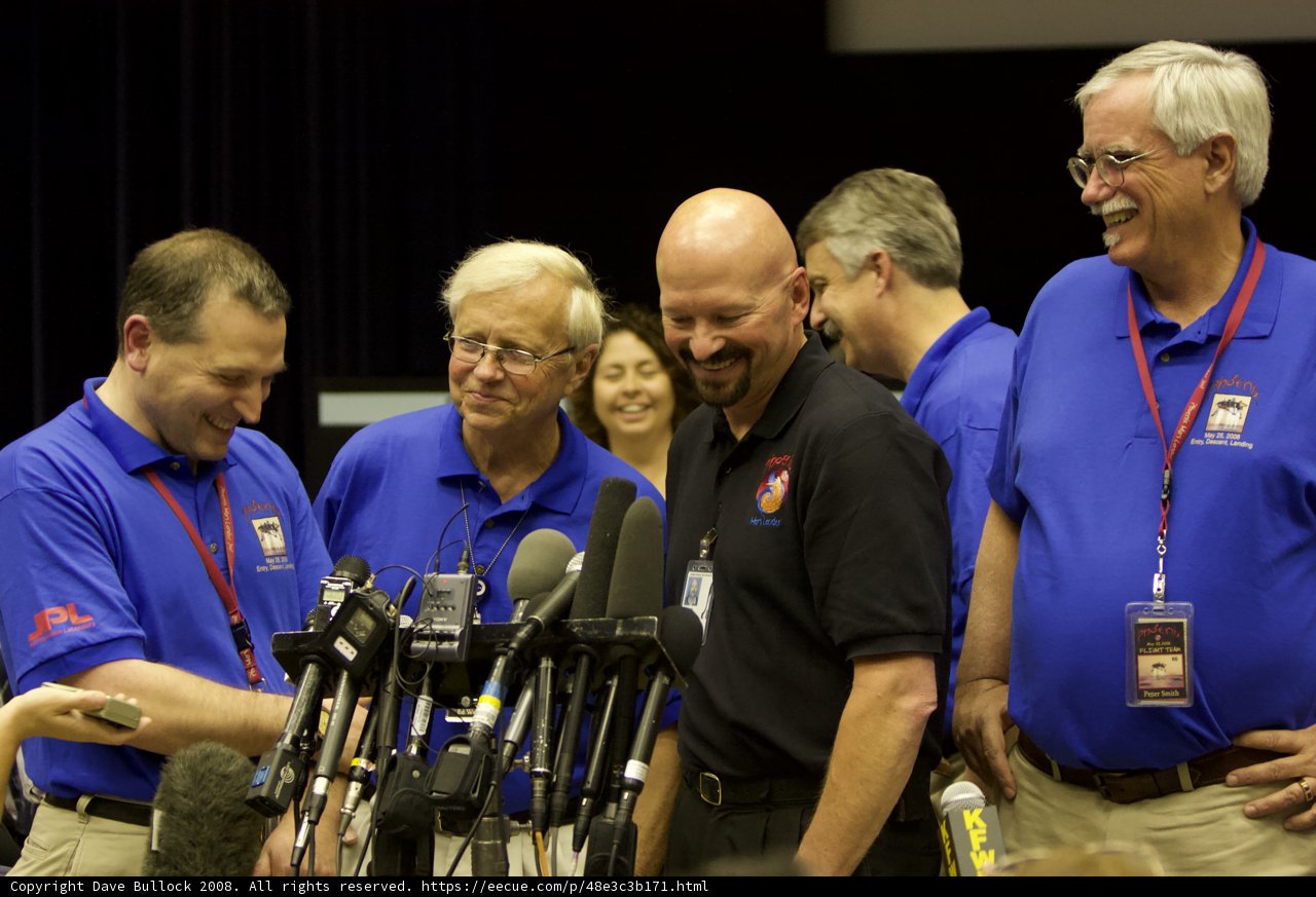 Blue Shirted Men in the Press Conference