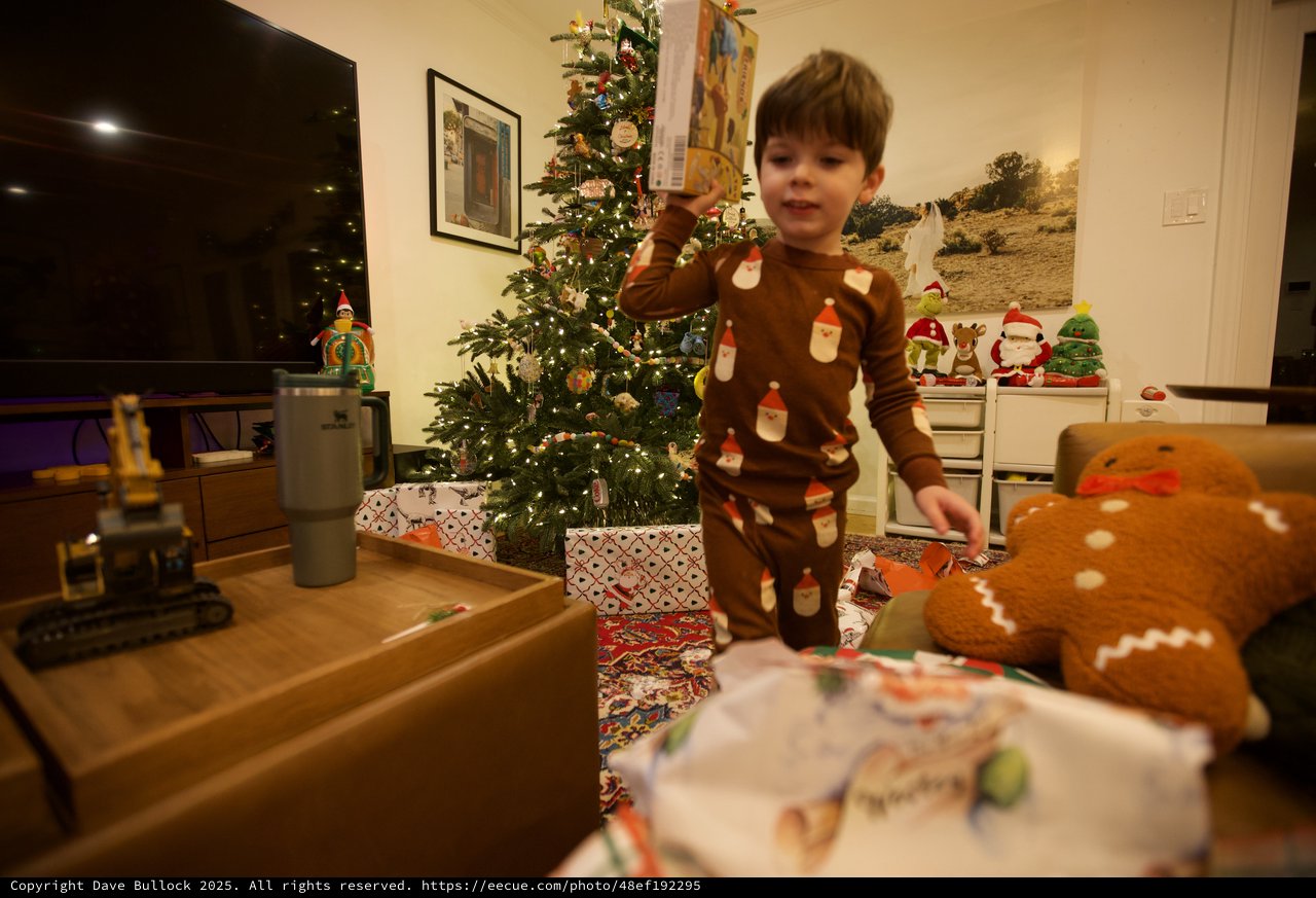 Child Opening Christmas Presents on Christmas Morning