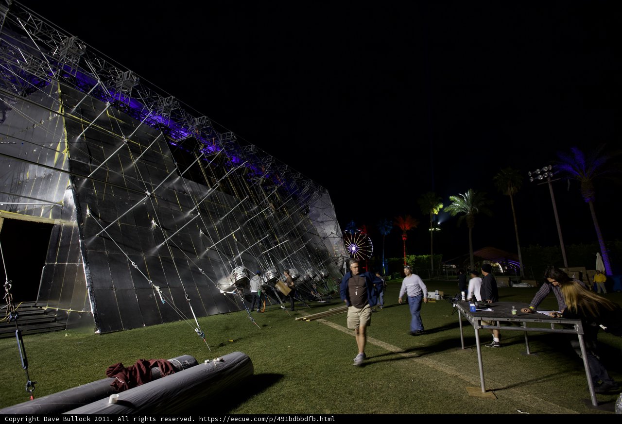 Nighttime gathering around a striking structure