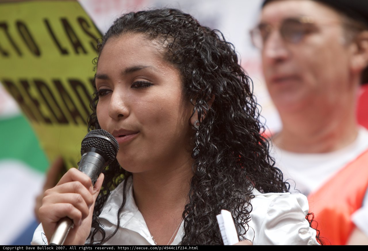 A Woman's Voice Caption: The power of a microphone in a woman's hand as she addresses the crowd during the 2007 Great American Boycott.