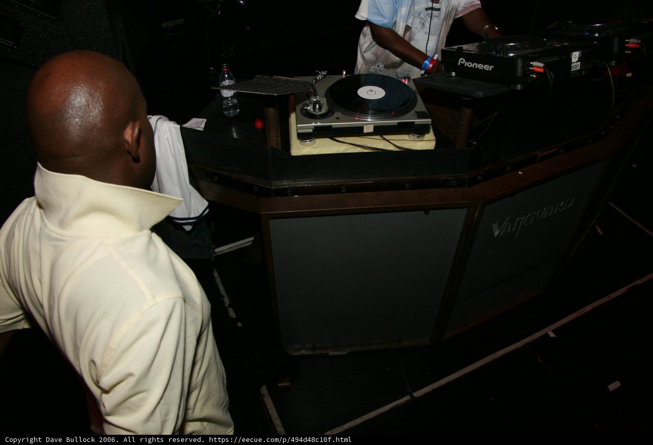 MC Q spinning some tunes Caption: MC Q shows off his skills on the turntable while entertaining the crowd with his music.