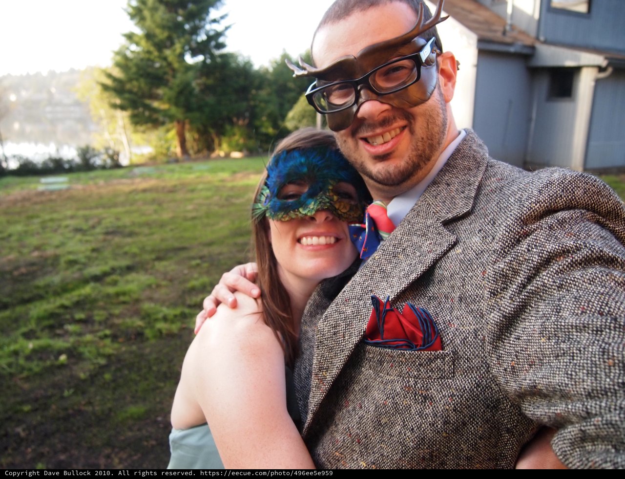 Masquerade Couple Posing Outdoors in Festive Costumes