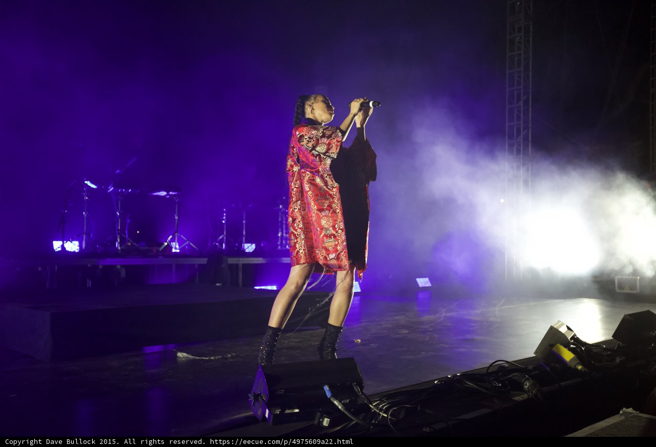 FKA twigs Full Body Stage Edge Singing Looking Up Kimono Open Red Brocade Gold Patterns Black Bodysuit Boots Purple Lighting White Haze Truss