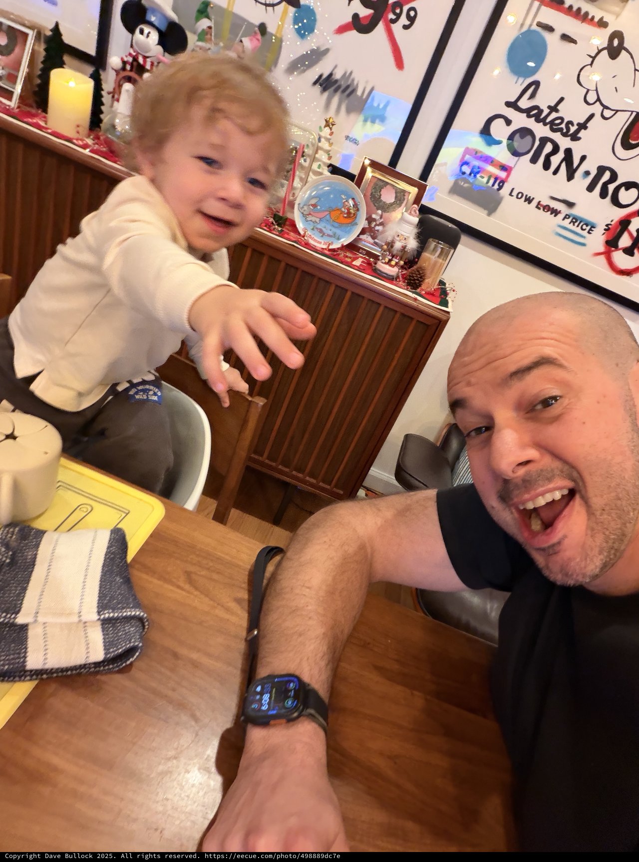 Father and Toddler Selfie at Festive Dining Table