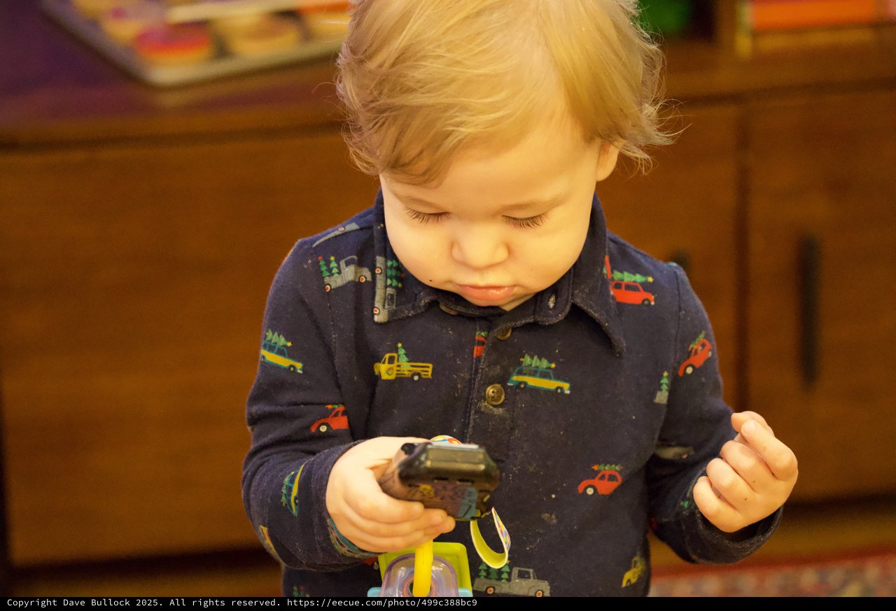 Toddler Playing with Toy Trucks on Christmas Eve