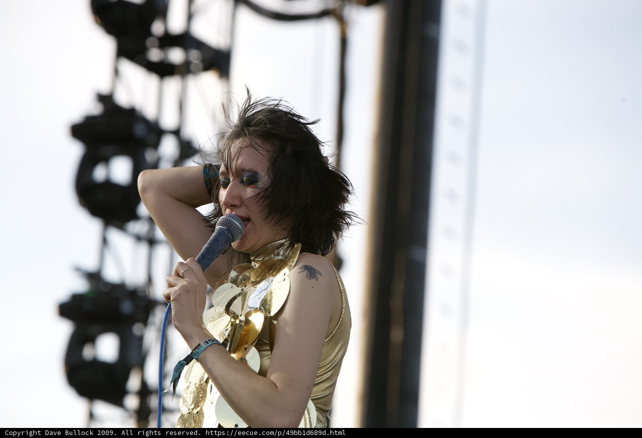Gold-dressed Singer Strikes a Tune with Her Microphone