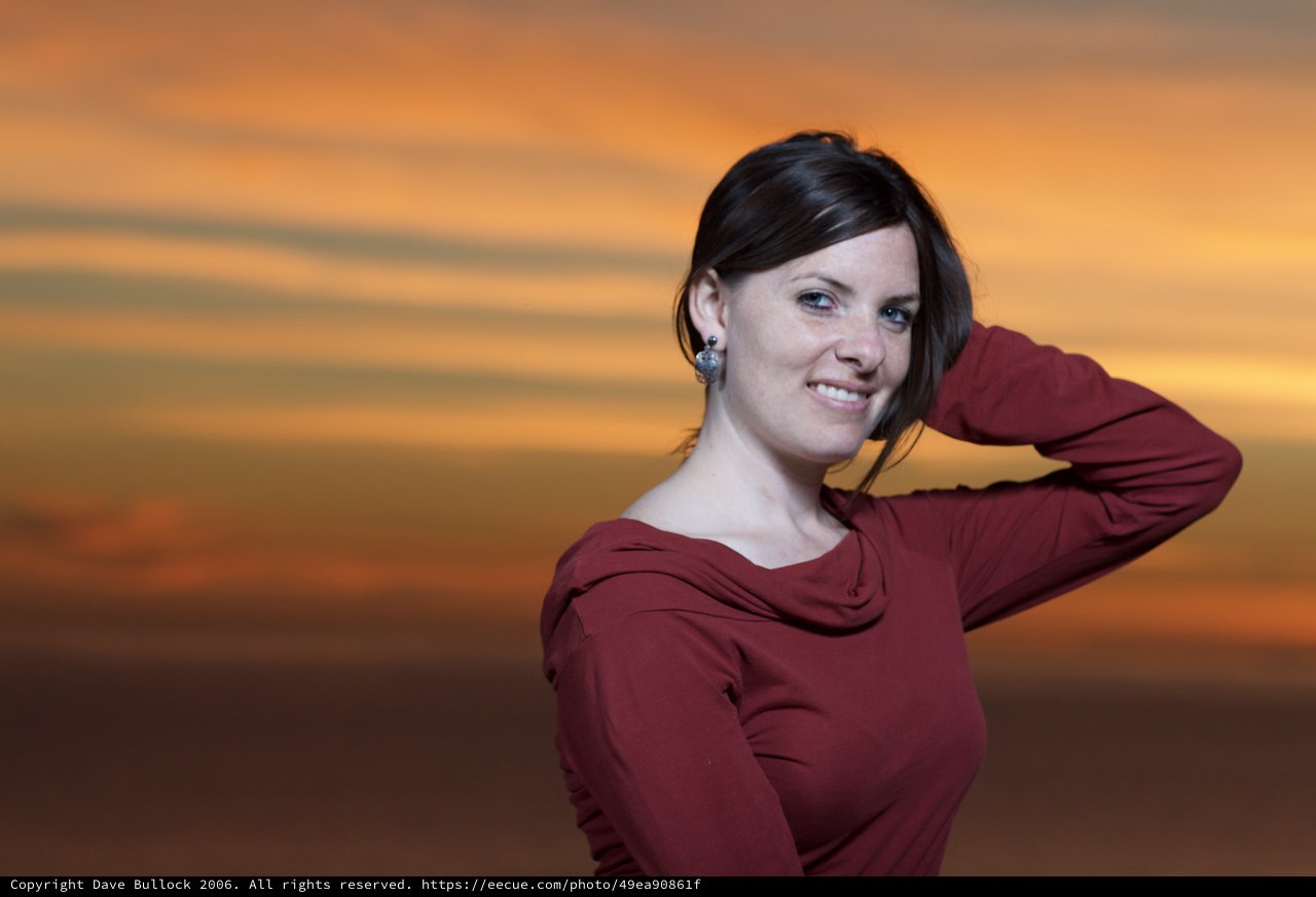 Woman in Red Against a Blazing Sunset Sky