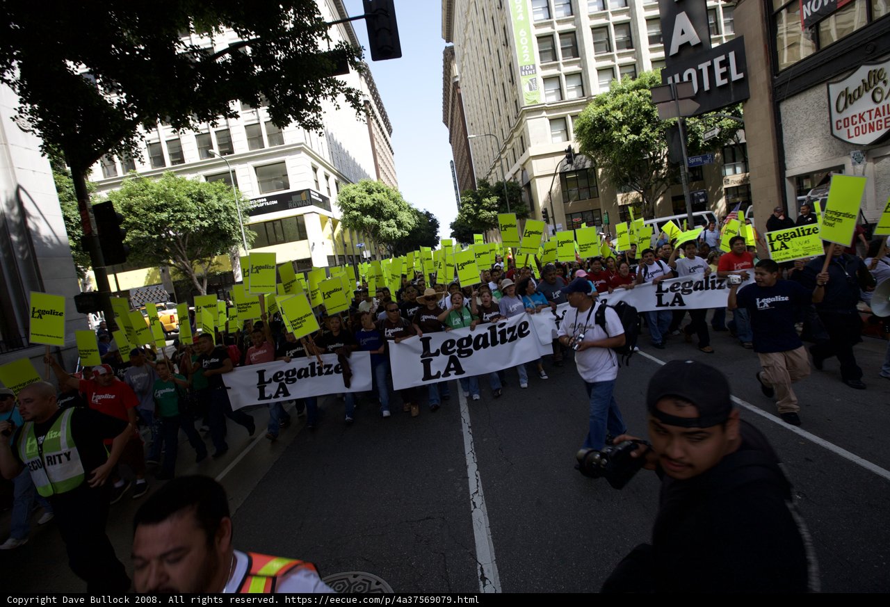 May Day Protesters Take to the Streets with Bold Signs