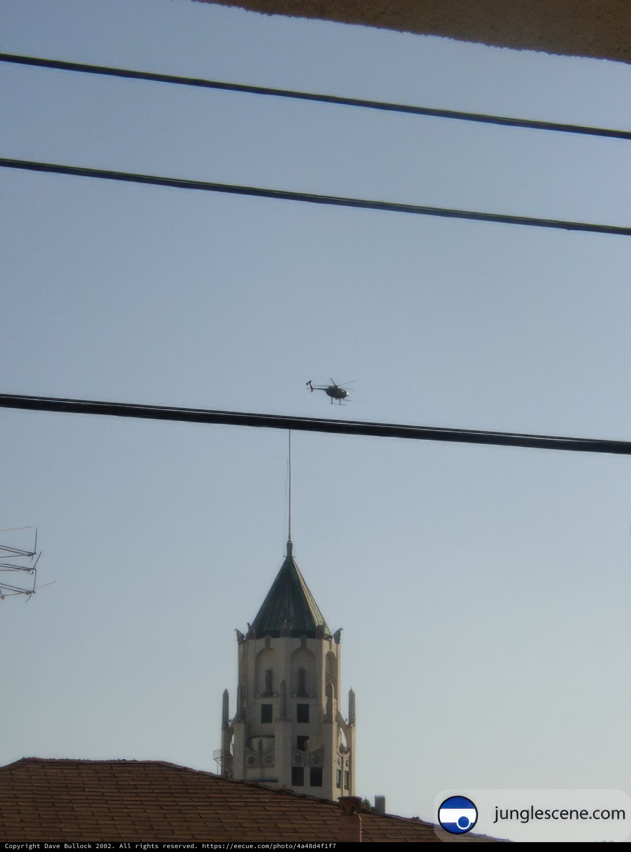 Helicopter Flying over Clock Tower Building