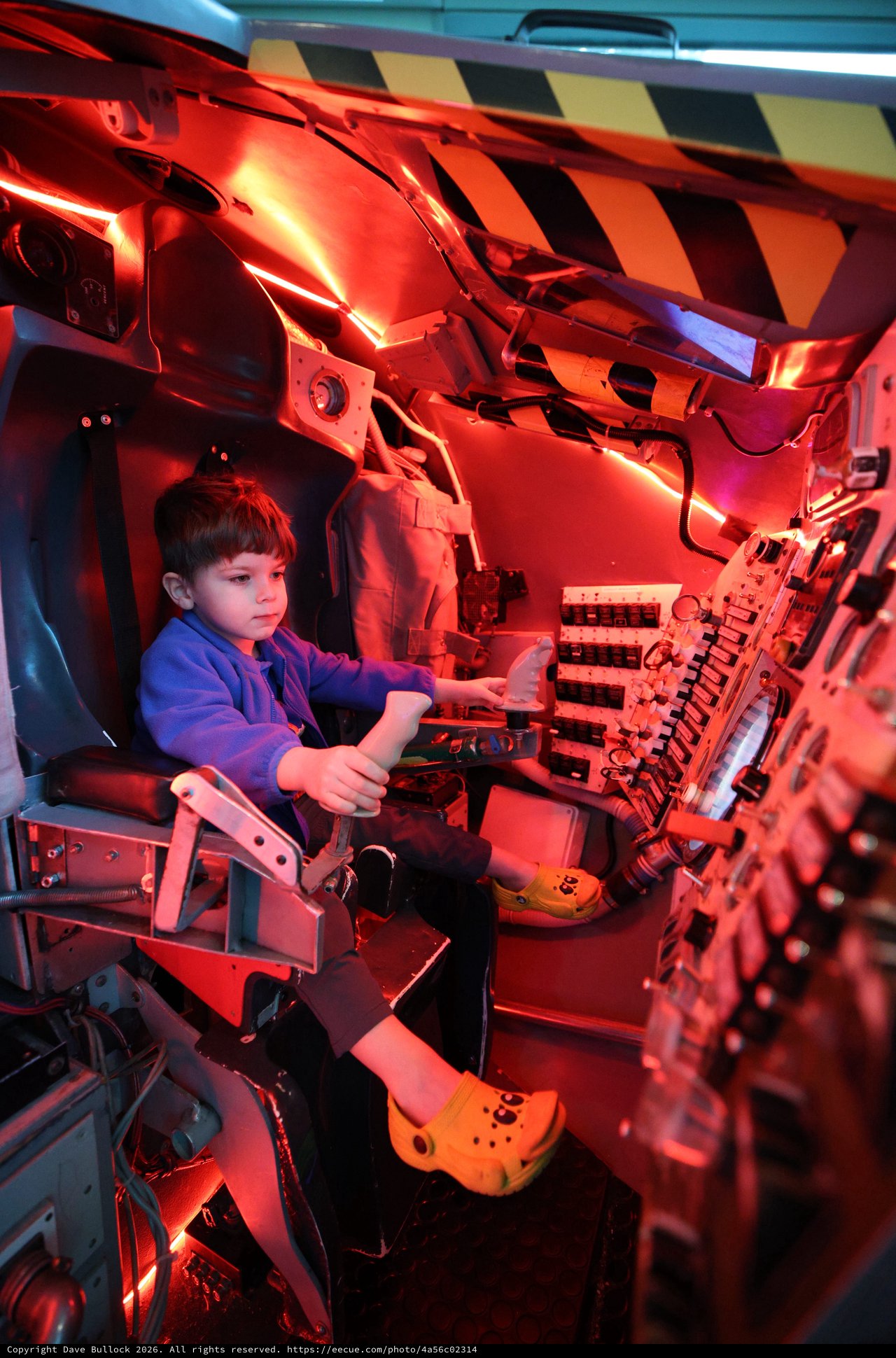 Young Pilot in Illuminated Aircraft Cockpit Simulator