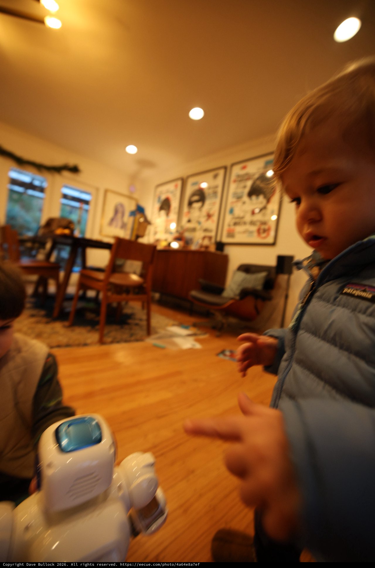 Young Child Playing with Toy Robot at Home