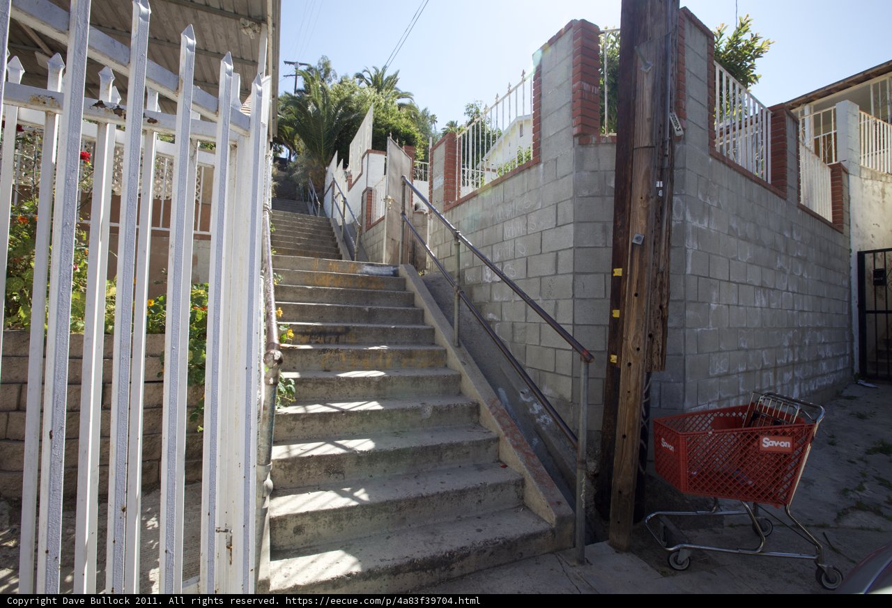 Red Cart Stands Out Against Stairway Scene
