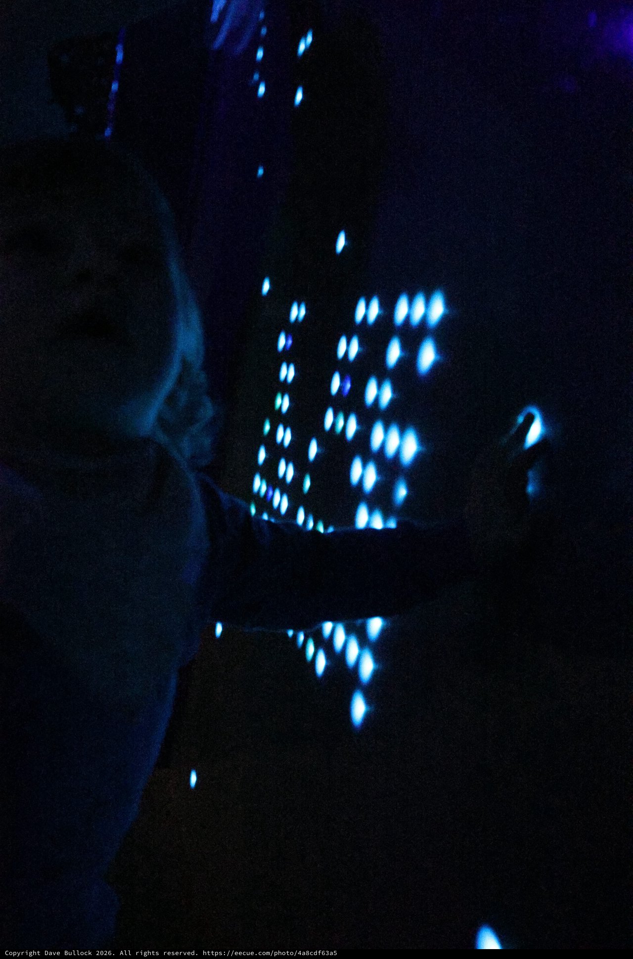 Blue Illuminated Perforated Pattern in Darkness