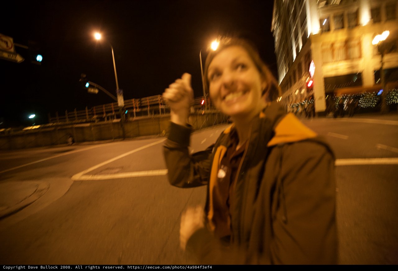 Jubilant Thumbs Up on Empty City Streets at Night