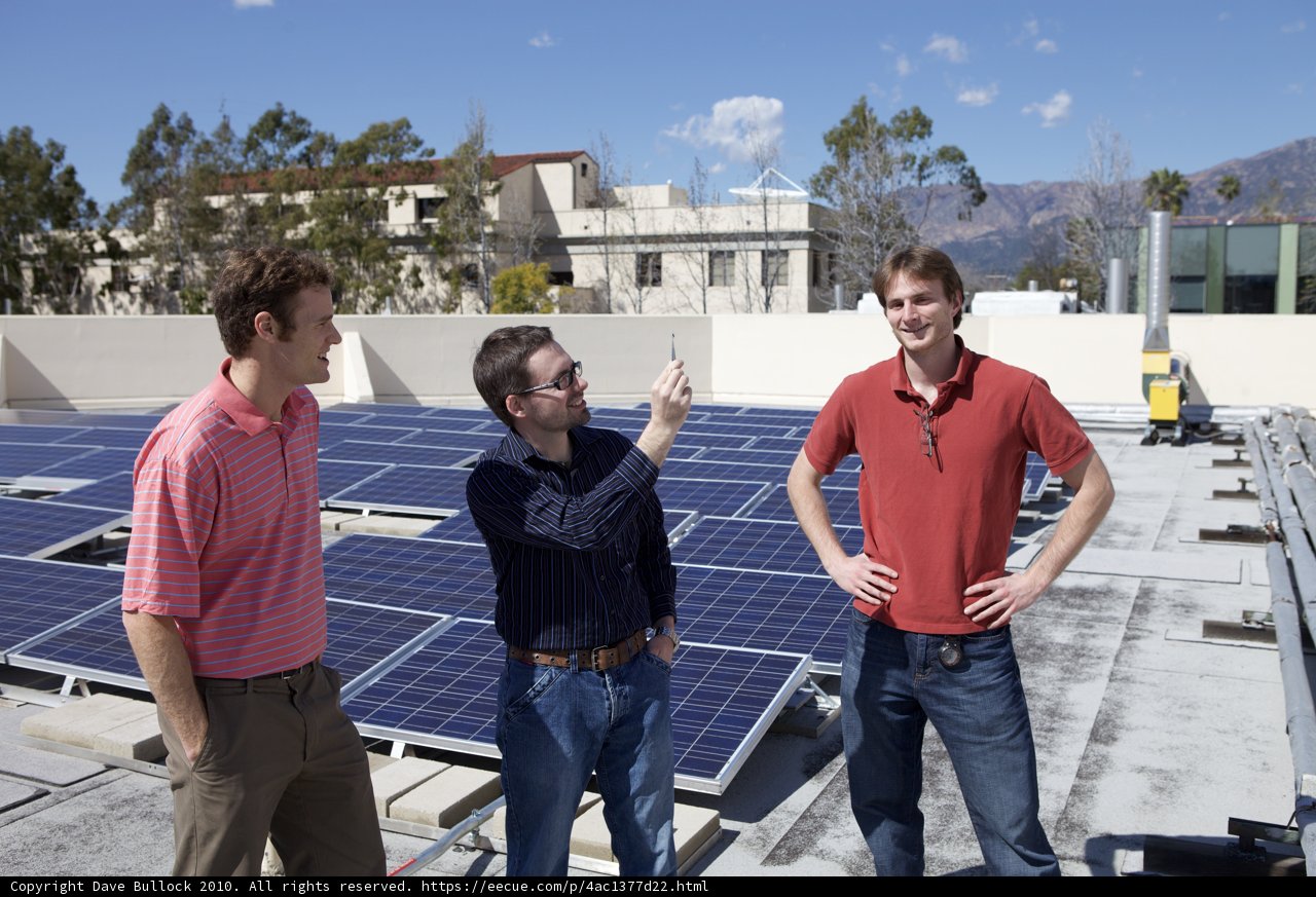 Men at Work: Installing Solar Panels on a Rooftop