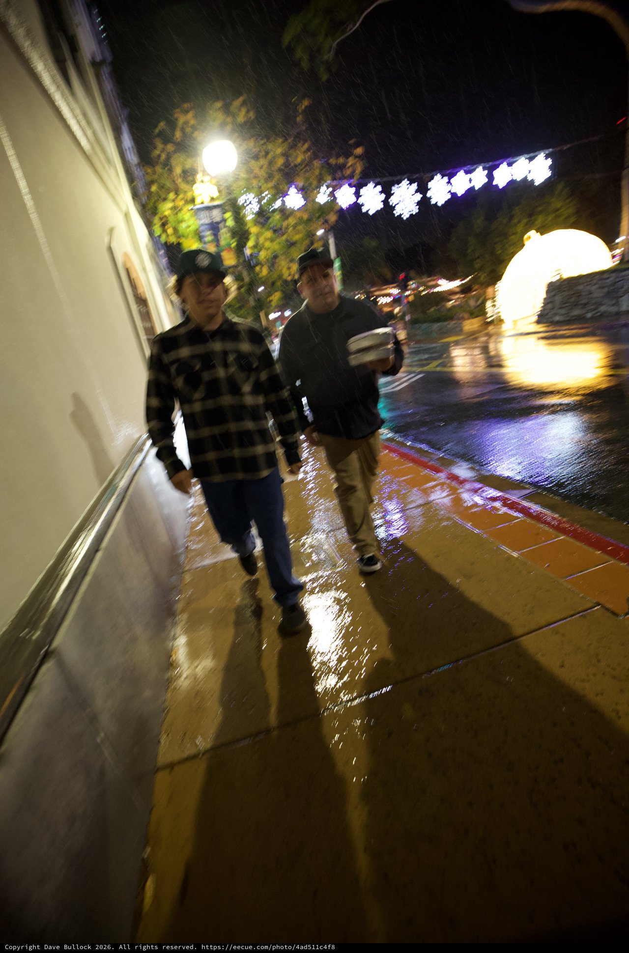 Rainy Night Walk on Illuminated Downtown Street