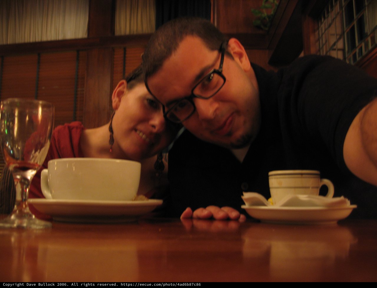 Couple Poses Cheek to Cheek at Restaurant Table