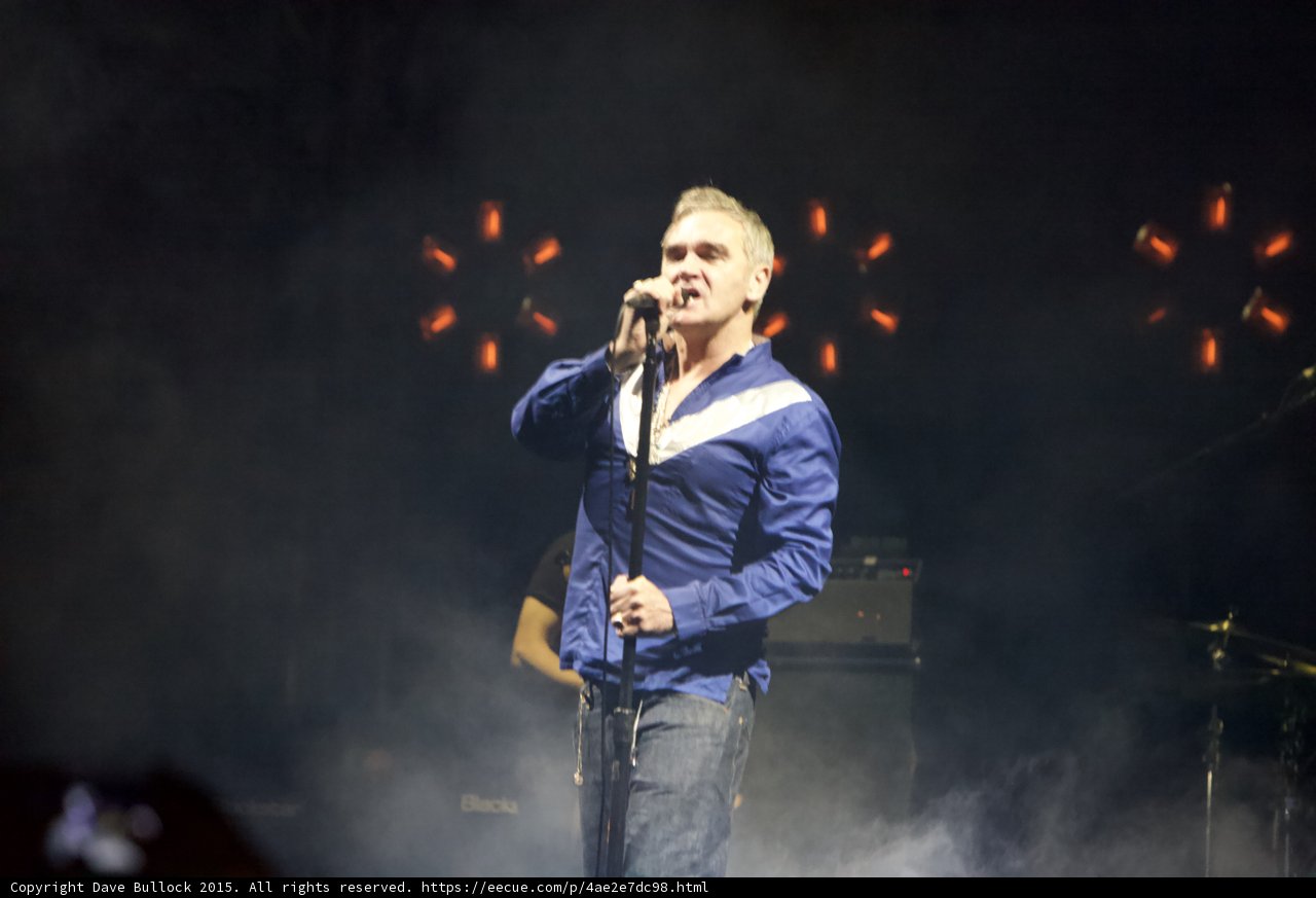 Morrissey Singing Three Quarter Blue Shirt White Stripe Orange Lights Haze Stage