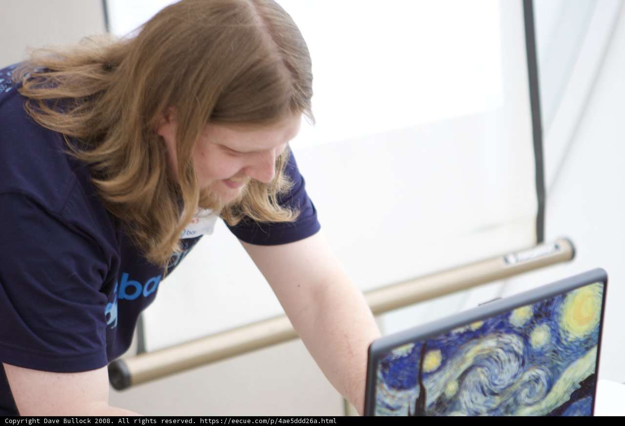 Long-Haired Man Working on Laptop