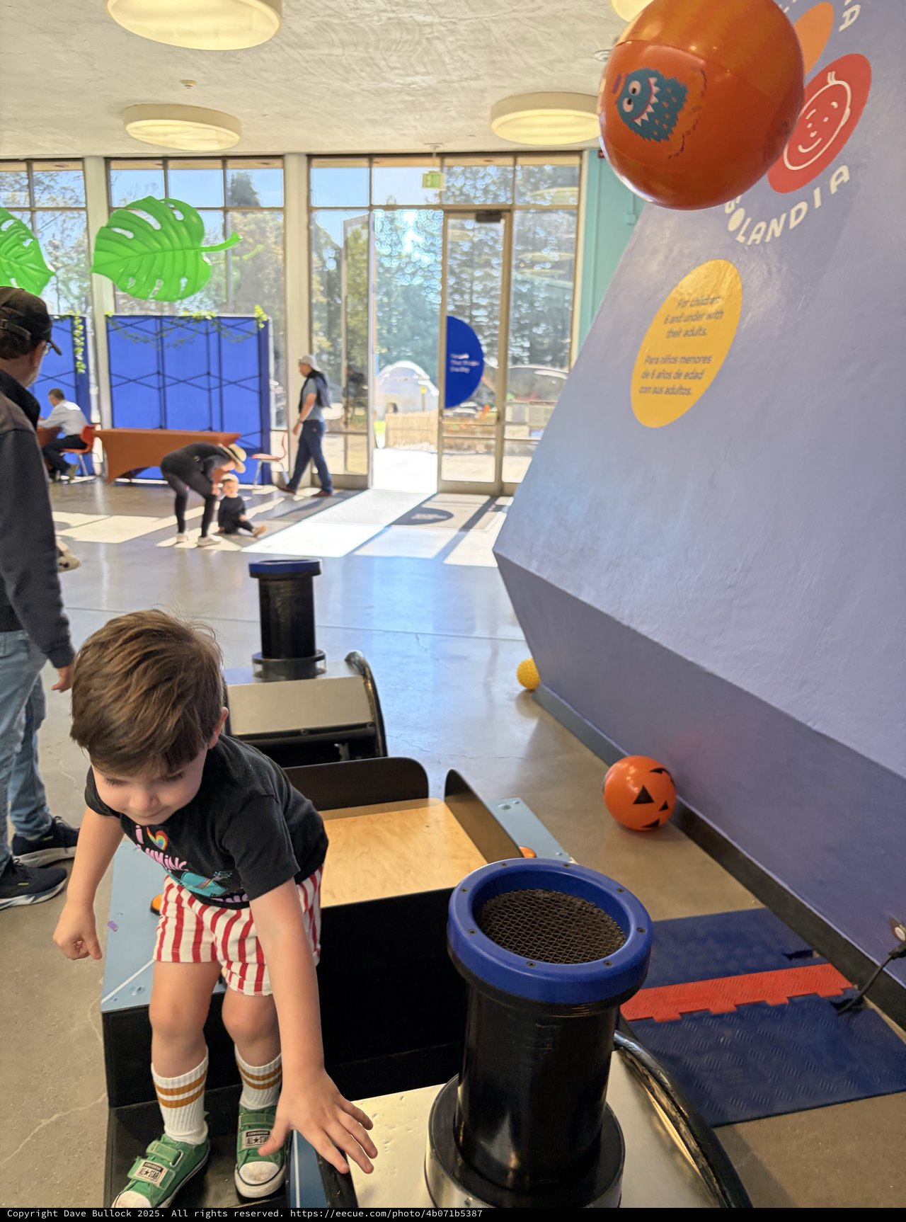 Child Exploring Interactive Science Exhibit at Museum