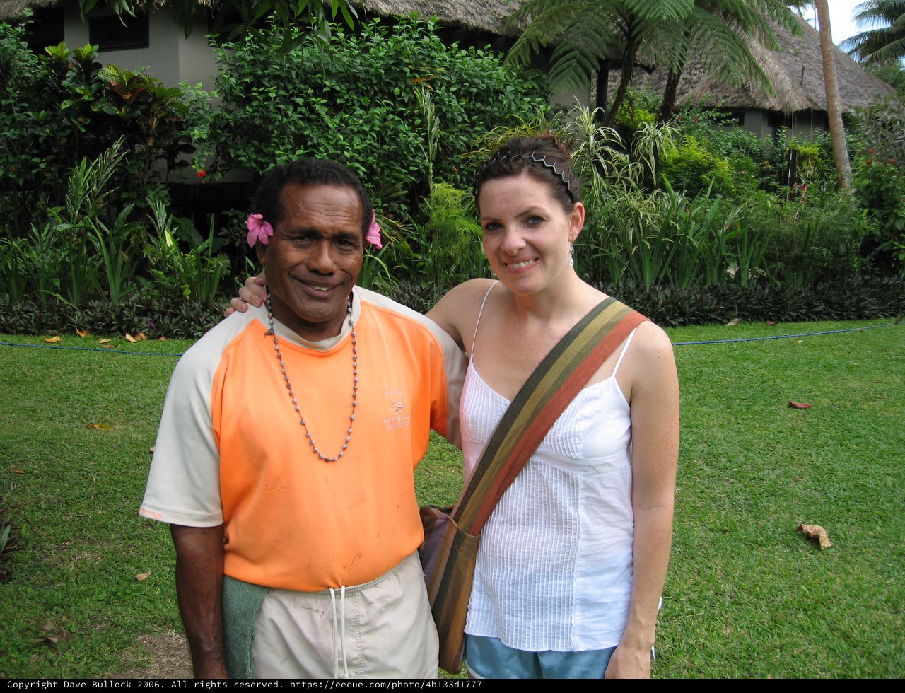 Smiling Travelers Pose at Tropical Resort Garden