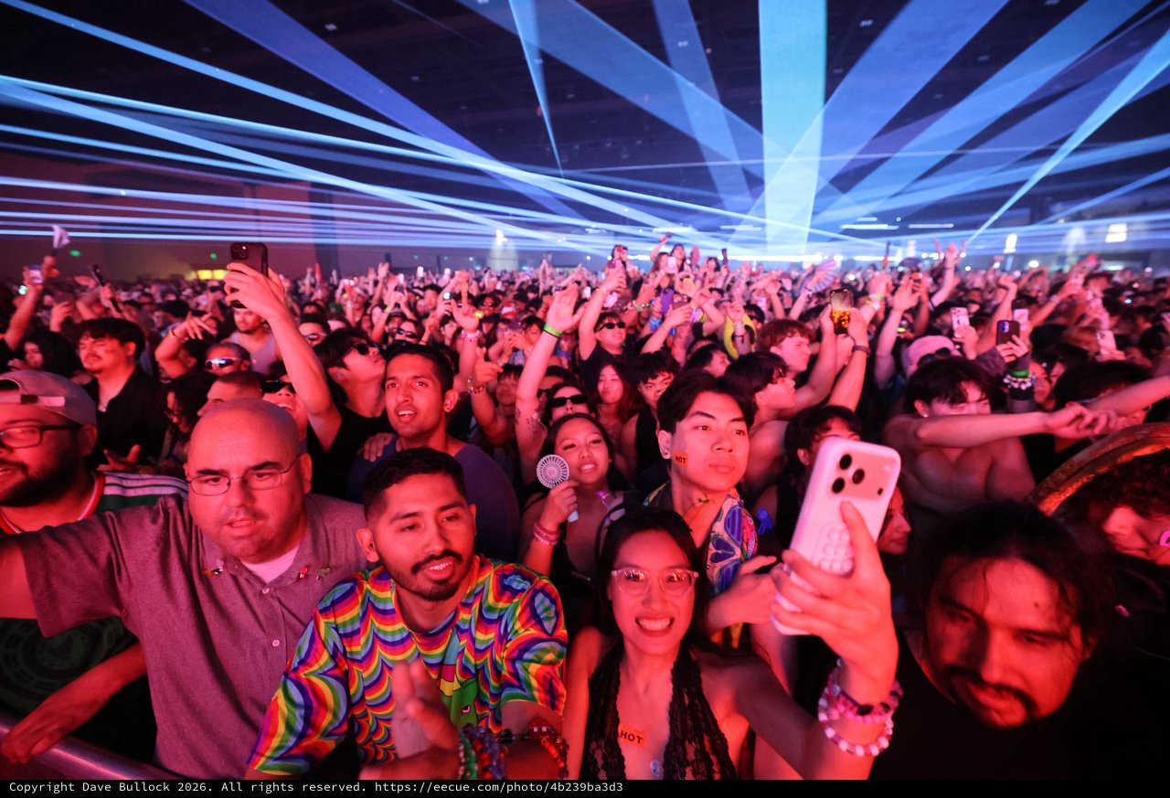 Massive Crowd Electrified Under Laser Light Show