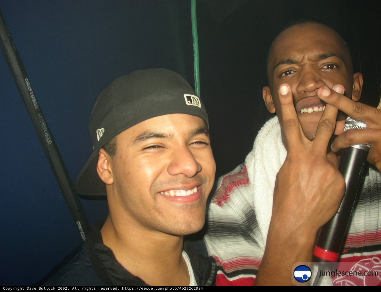 Two Men with Microphone and Baseball Caps
