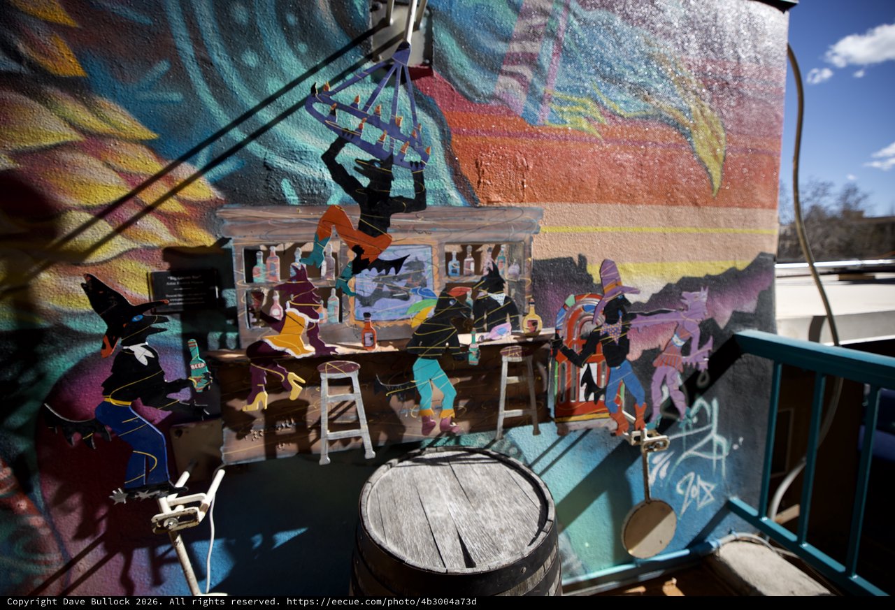 Layered Art Installation with Mural Backdrop at Bar Scene