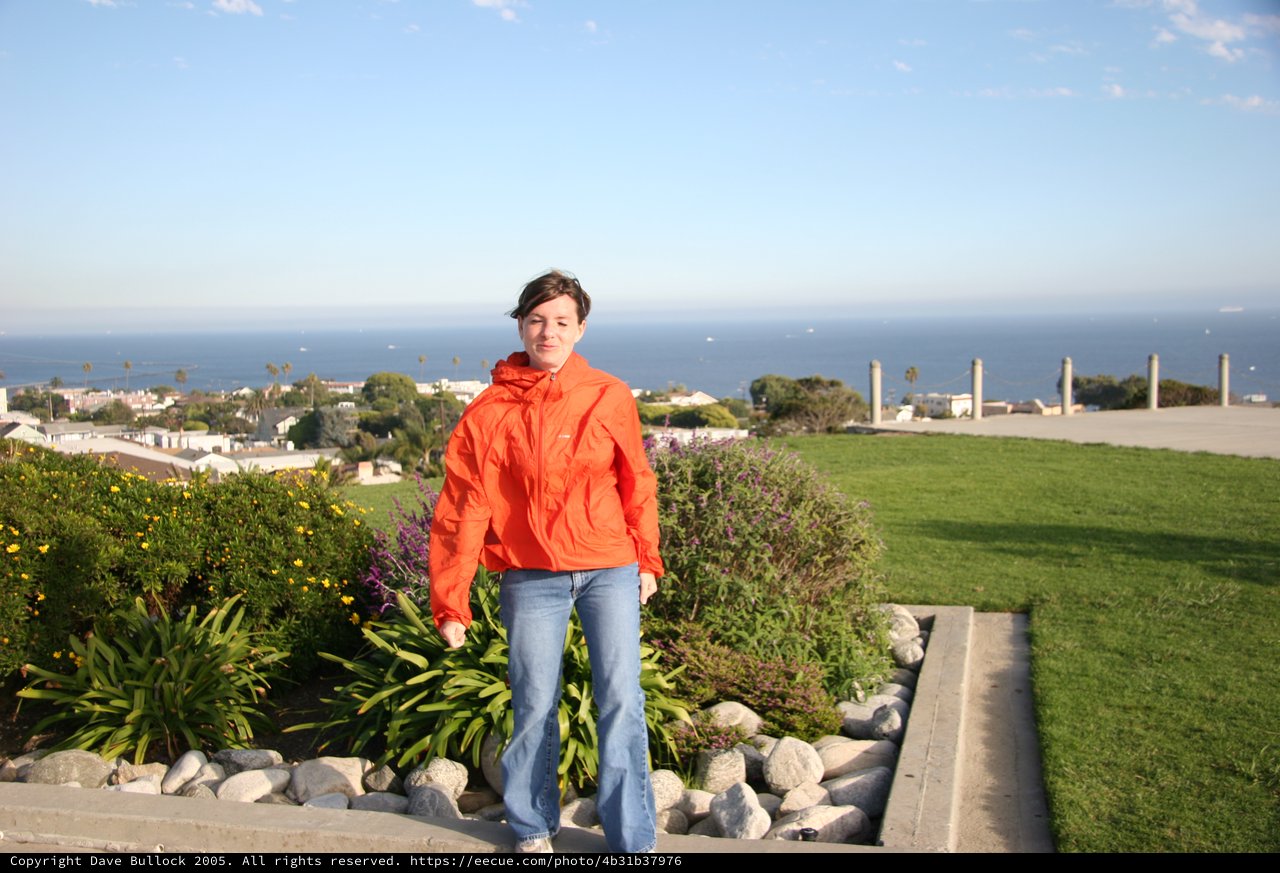 Woman in Orange Jacket Overlooking Coastal California Town