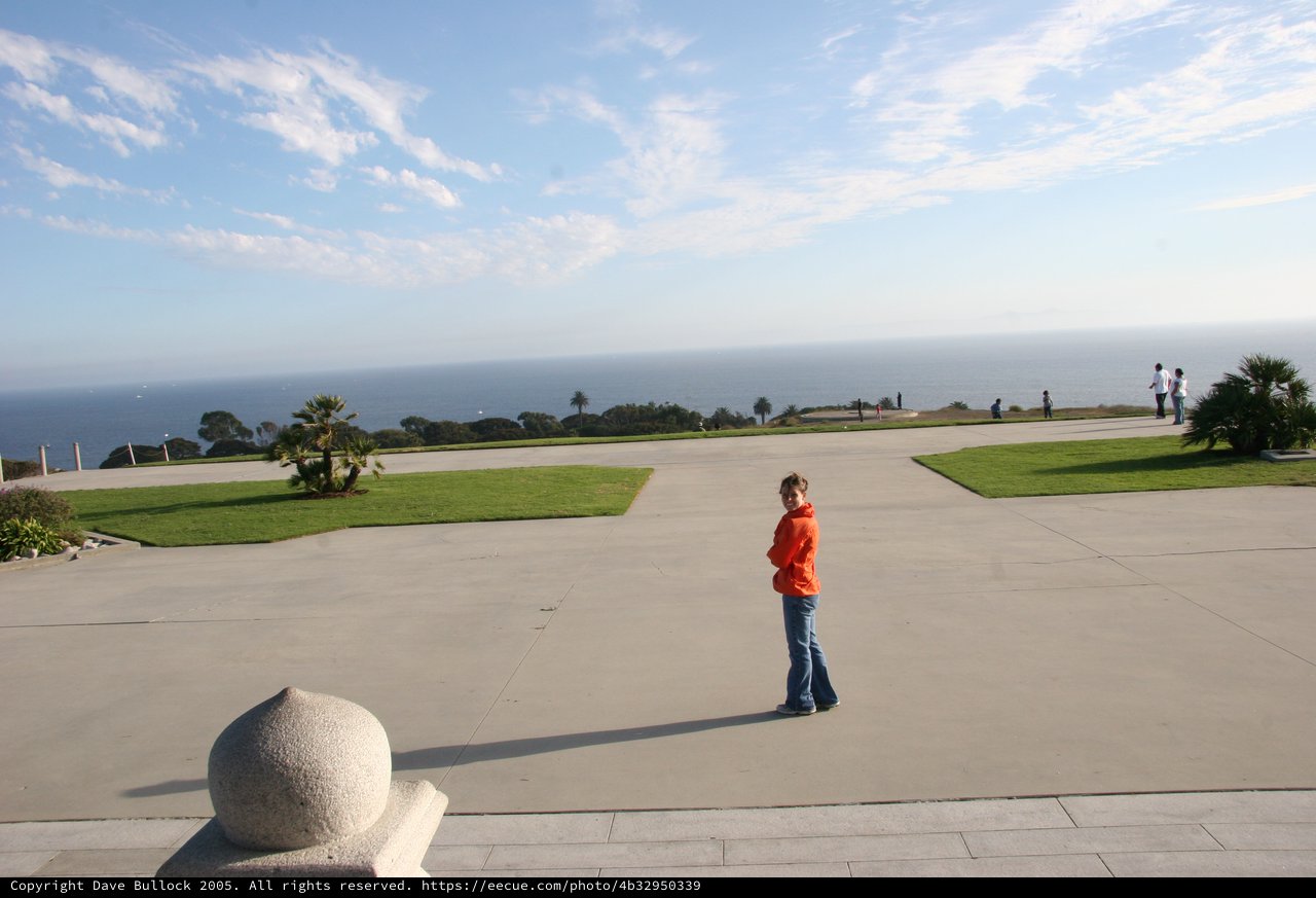 Young Girl Gazes at Pacific Ocean Overlook