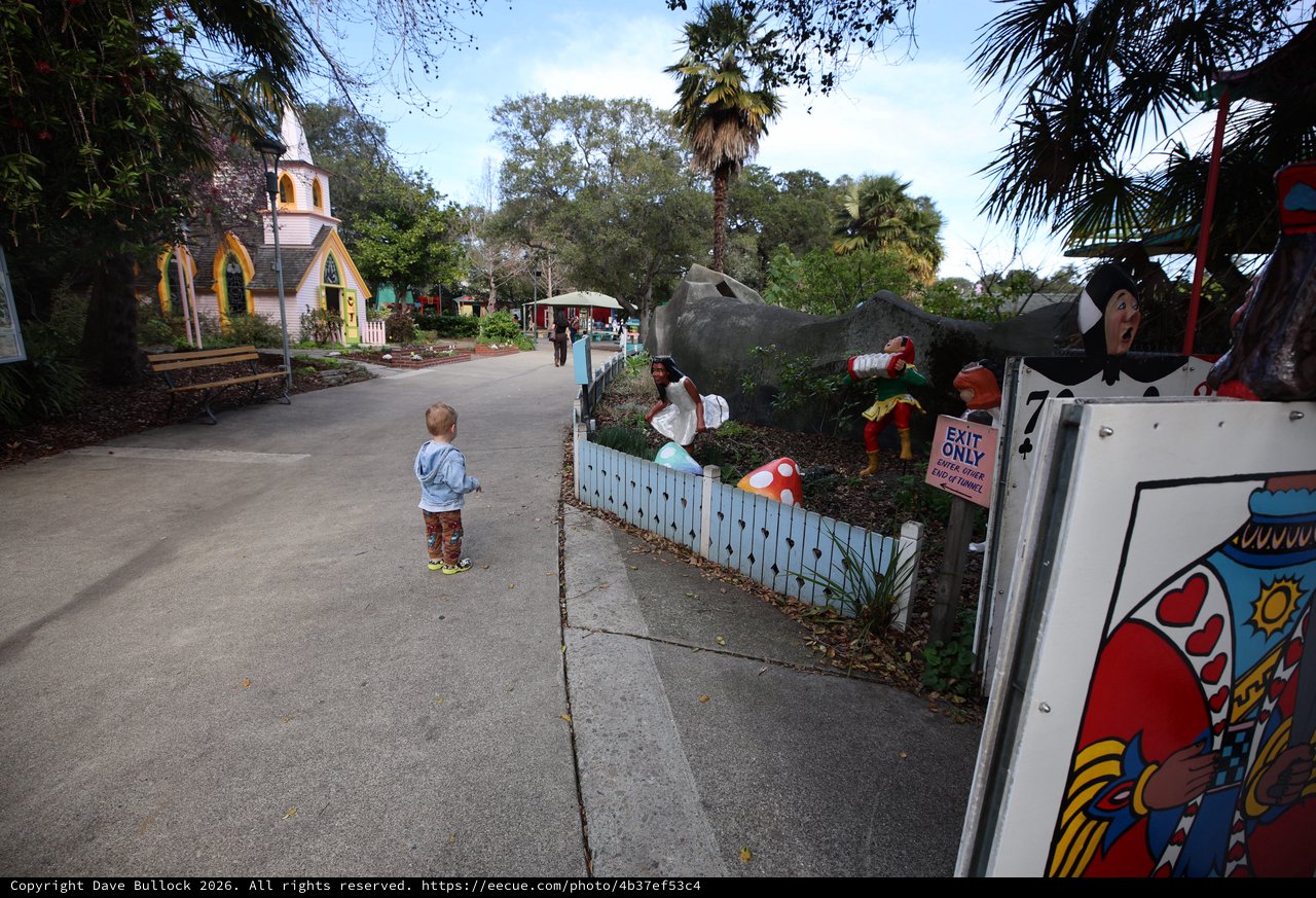 Child Exploring Storybook-Themed Miniature Village at Dusk