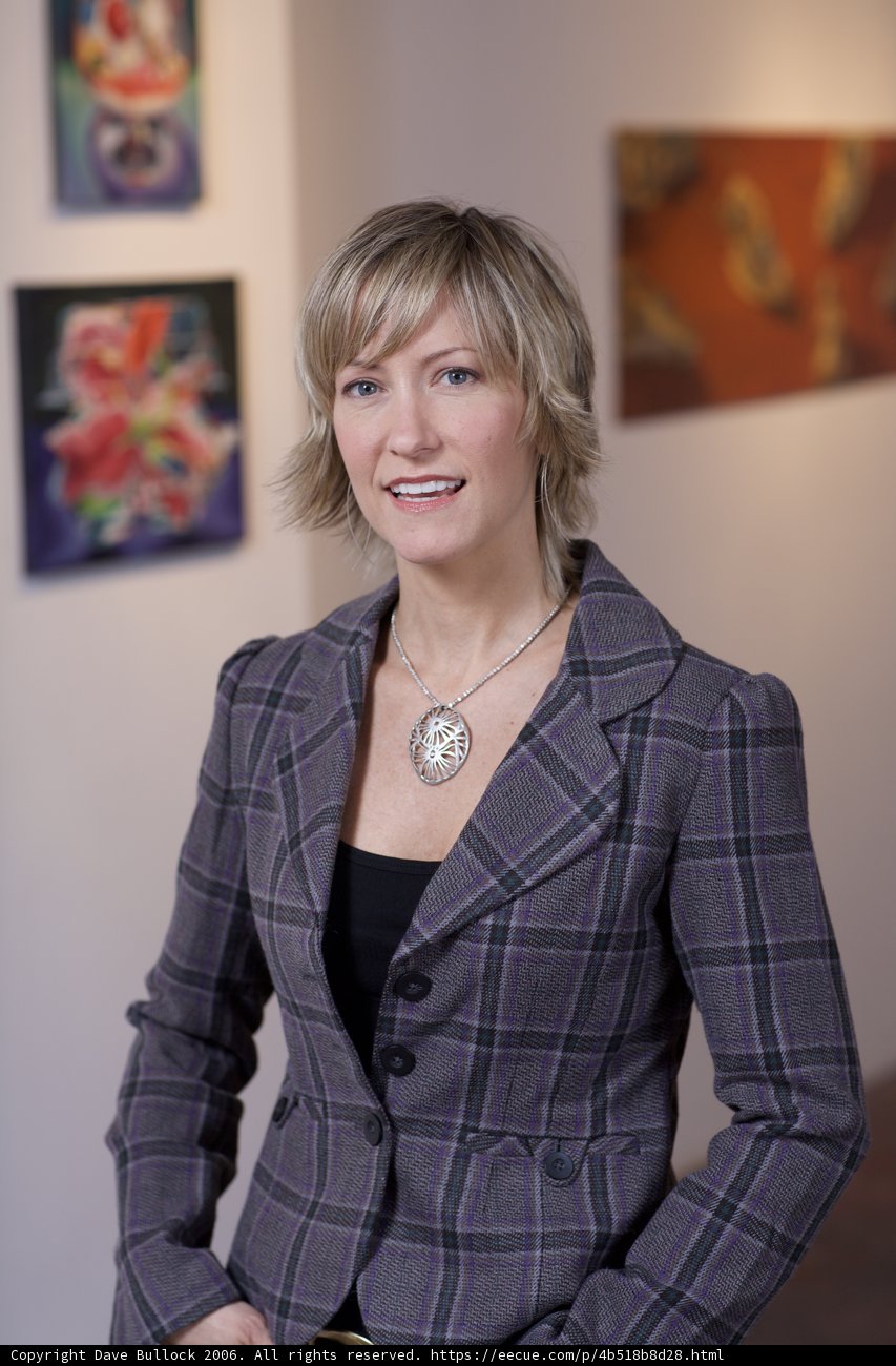 Woman in Suit Admiring Artwork