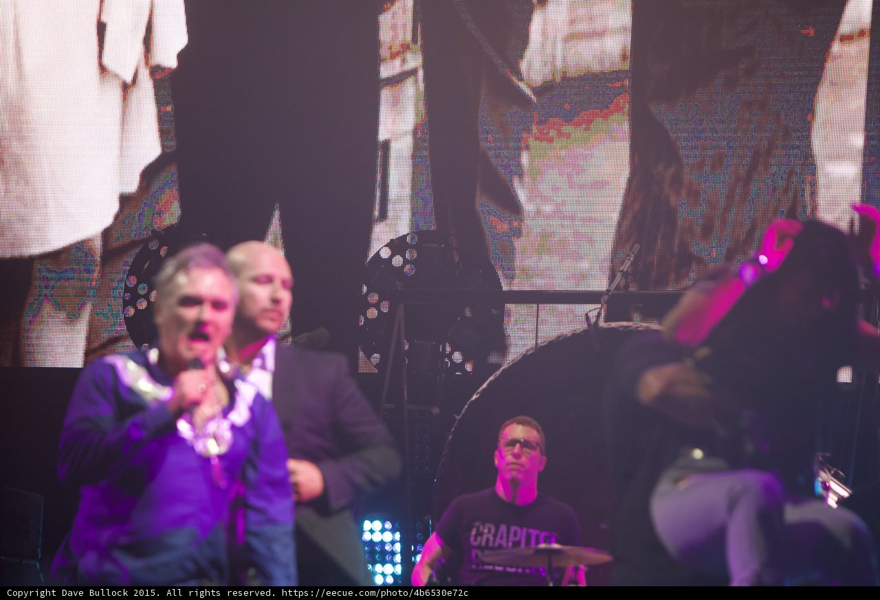 Morrissey Singing Blue Shirt Necklaces Security Guard Suit Behind Drummer Glasses Capitol Tee Gong Smiths Screen