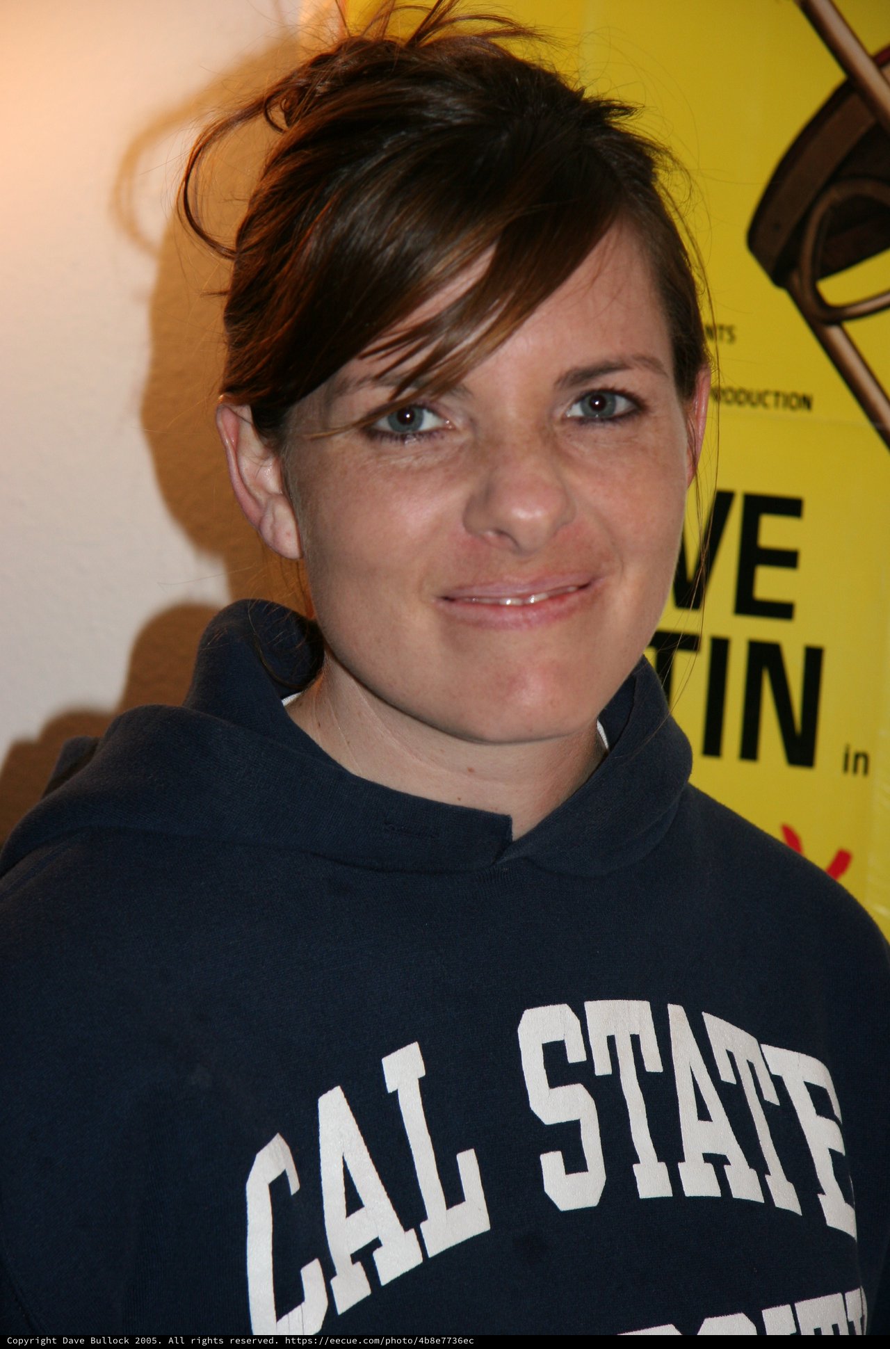 Woman in Cal State Hoodie at Event Backdrop