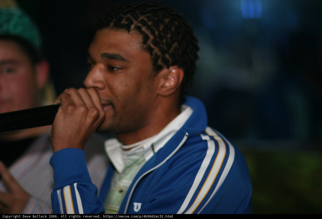 Dreadlocked Performer Holds Microphone
